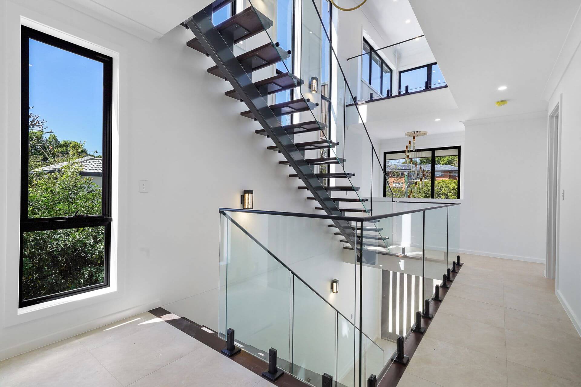 Staircase inside a tri-level sloping block home by BESA
