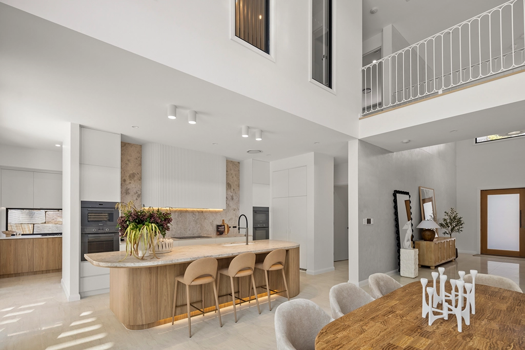 Open-plan kitchen and dining area at Canopy, showing the double-height void and connected living spaces.