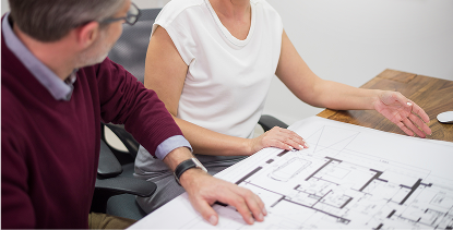 BESA in-house design and drafting consultation reviewing custom home floorplans